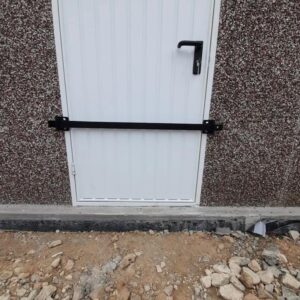 White door with security bar fitted across it.