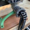 Vintage mincing machine with chains coming out of the front