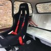 The inside of a mini showing the bar used to secure a racing seat to the rear seat.