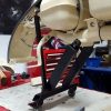 A dolly which fits to a scooter frame via the standard engine mount and the shock mount and allows you to move/store your engineless scooter with ease. title