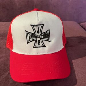 Child's trucker cap in red and white with the JB Fabrication logo embroidered in black on the front.
