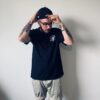 Model wearing black t-shirt with JB Fabrication logo