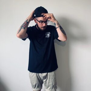 Model wearing black t-shirt with JB Fabrication logo