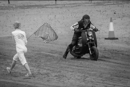 A Triumph Tigress scooter being raced along Bridlington beach