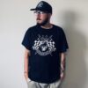 Model wearing black Brandon t-shirt featuring JB Fabrication logo and skull