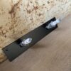Upcycled spark plugs fitted to a metal rack to use for hanging your coat or storing keys