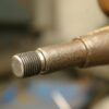 Closeup of a metal rear shock absorber pin on a Lambretta