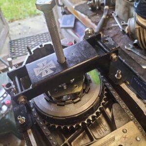 A folding clutch compressor shown in action compressing a Lambretta clutch.