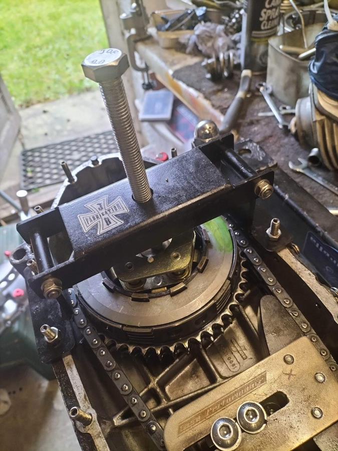 A folding clutch compressor shown in action compressing a Lambretta clutch.