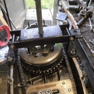 A folding clutch compressor shown in action compressing a Lambretta clutch.
