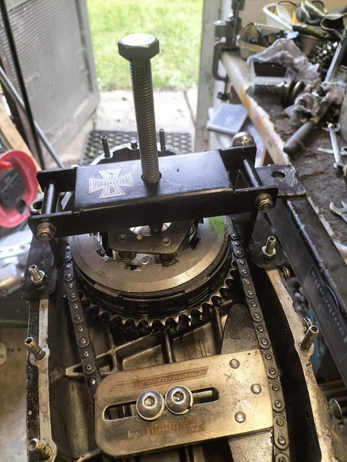 A folding clutch compressor shown in action compressing a Lambretta clutch.