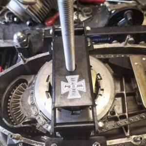 A folding clutch compressor shown in action compressing a Lambretta clutch.