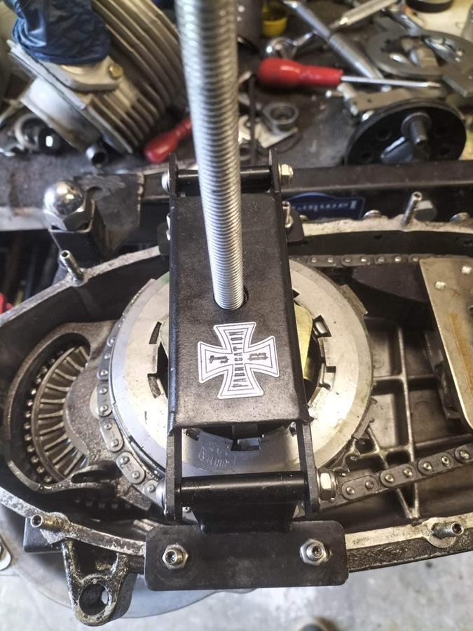 A folding clutch compressor shown in action compressing a Lambretta clutch.