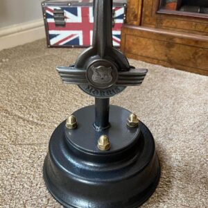 Closeup of the base of a morris minor coffee table featuring a Morris Minor badge