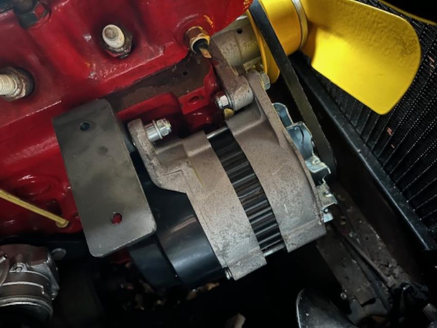 A bracket for a Morris Minor alternator/coil, shown in situ in a Morris Minor engine.