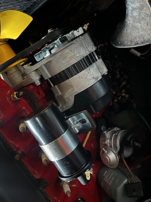 A bracket for a Morris Minor alternator/coil, shown in situ in a Morris Minor engine.