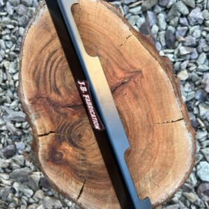 A battery retaining strap for a classic Morris Minor car. Shown on a piece of wood.