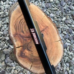 A battery retaining strap for a classic Morris Minor car. Shown on a piece of wood.