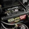 A close up of a battery strap on a Morris Minor engine