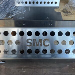 Closeup of personalised aluminium sump guard for a classic mini. It has 'SMC' cut out of the metal.
