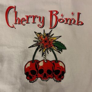 Close-up of white ladies t-shirt with Cherry Bomb design, with a bunch of cherries and red skulls instead of cherry fruit.
