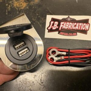 An in-car charger mount with tied cable and JB Fabrication sticker
