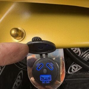 An in-car charger mount shown attached to a car dashboard