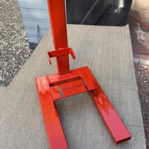 A red metal engine stand for Honda C50, C70 and C90 motorbikes.