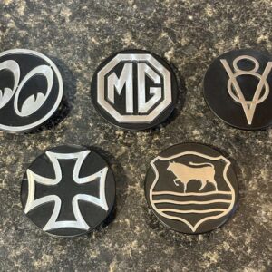 Set of 5 circular black toppers for dip and main beam switches in a car. Each has a different funky design in grey metal.